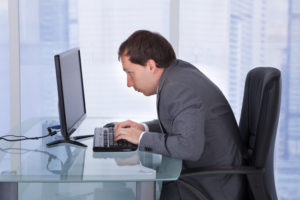 man sitting over computer