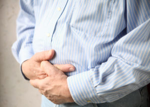 Businessman with bloating and bad stomach pain