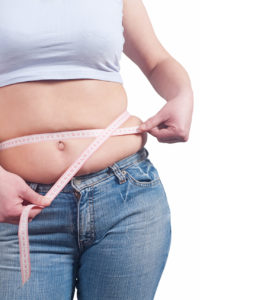 fat woman measuring her stomach to lose weight