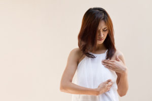 Woman checking for breast inflammation